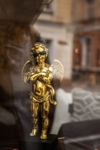 golden cupid statuette wearing sunglasses
